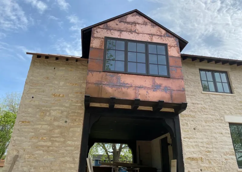 Copper metal panel facade on a stone building for Skylight Installation in Abington